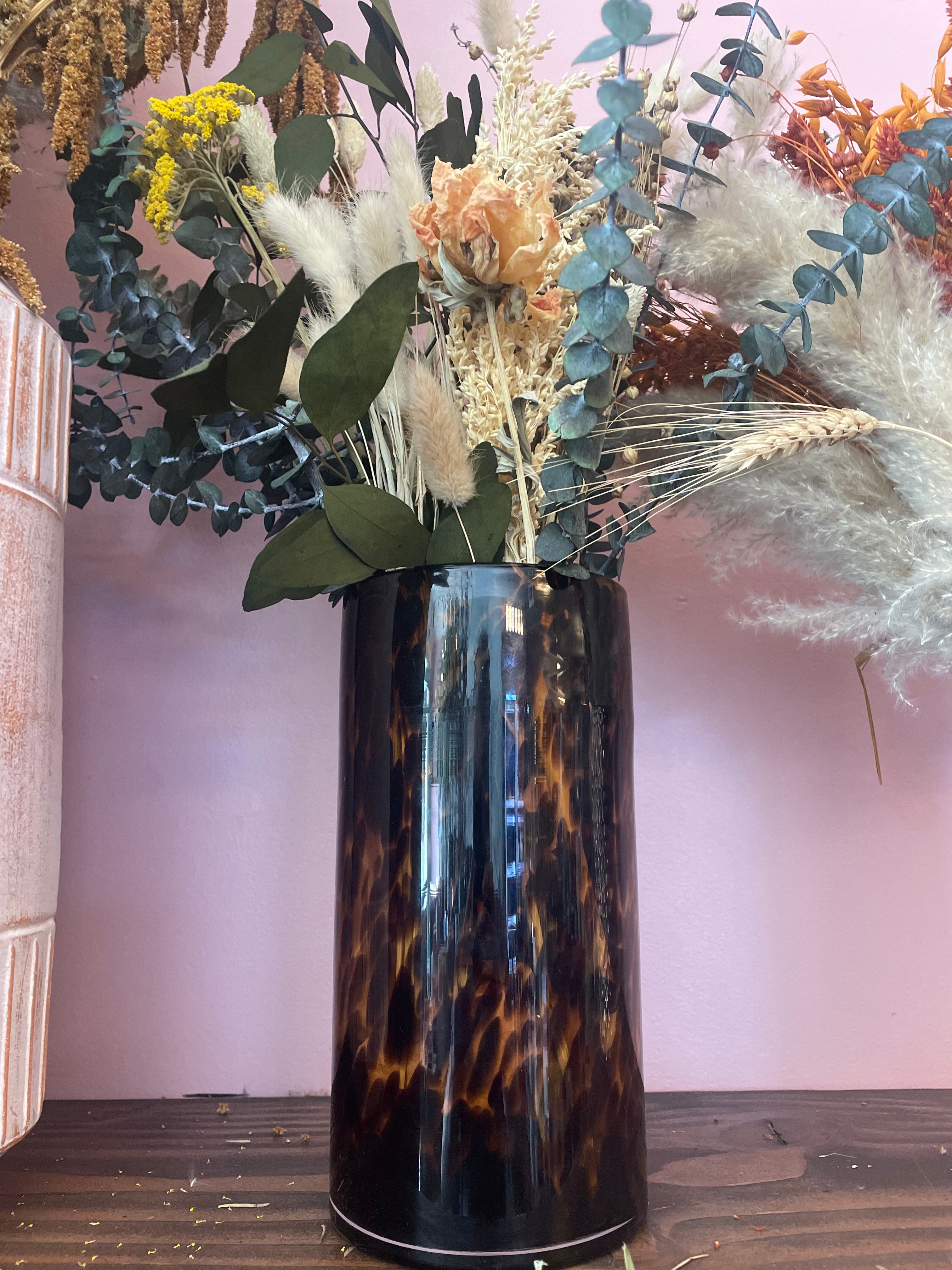 Dried flowers in brown vase