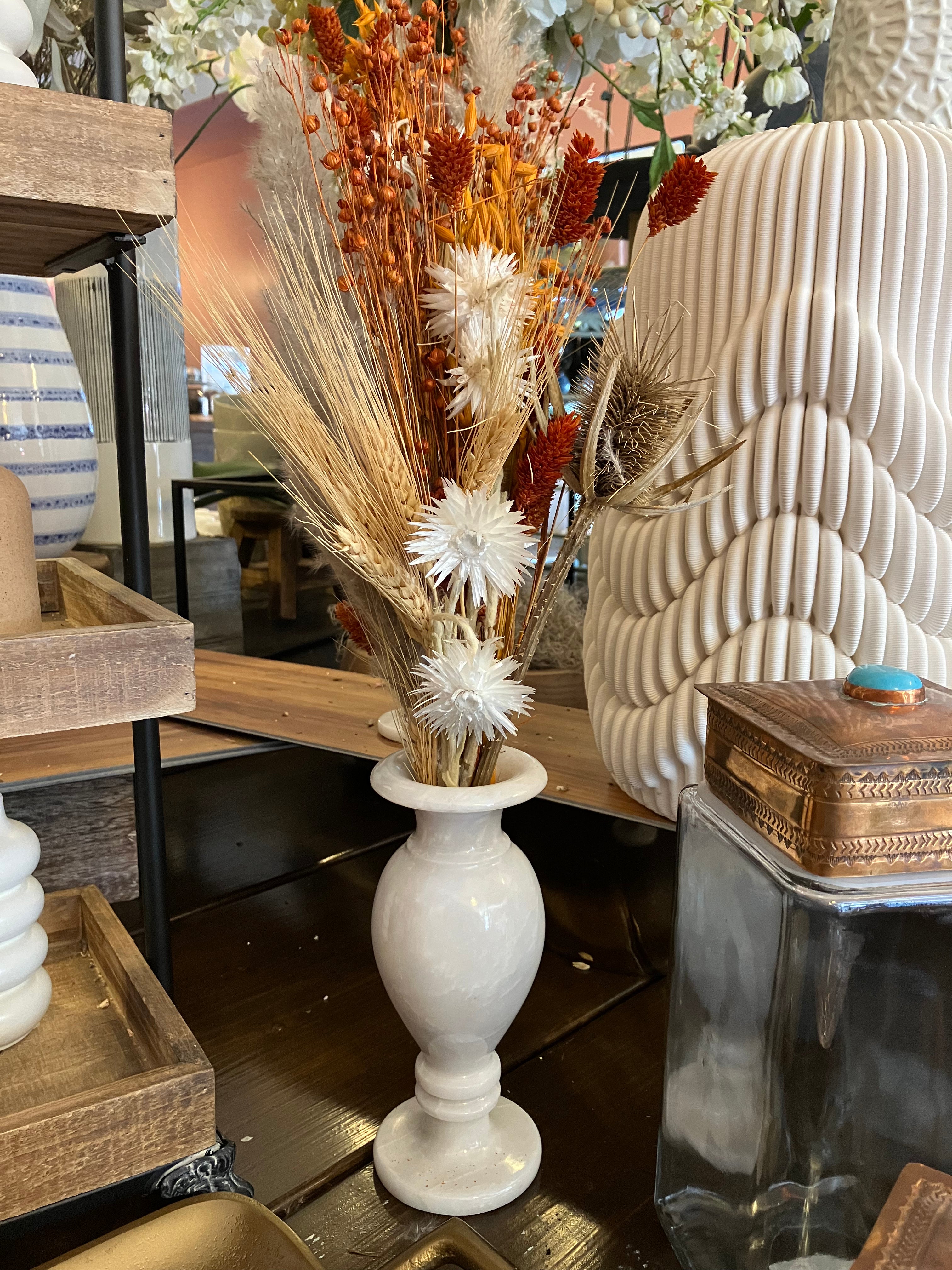 Dried flowers in white marble vase