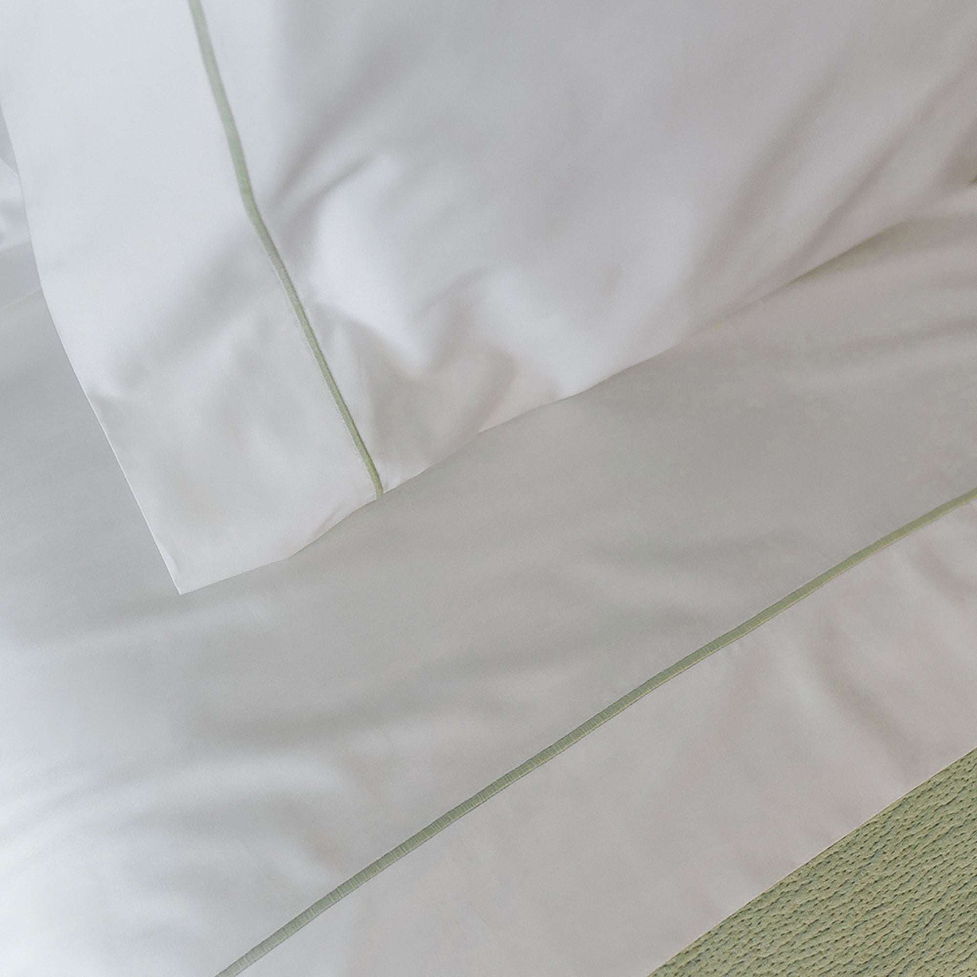 Close-up of the top sheet from the Serene Sheet Set by Rest & Reset, showing lightweight organic cotton texture
