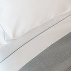 Close-up of organic cotton fabric from the Serene Sheet Set by Rest & Reset, showing a smooth and breathable weave