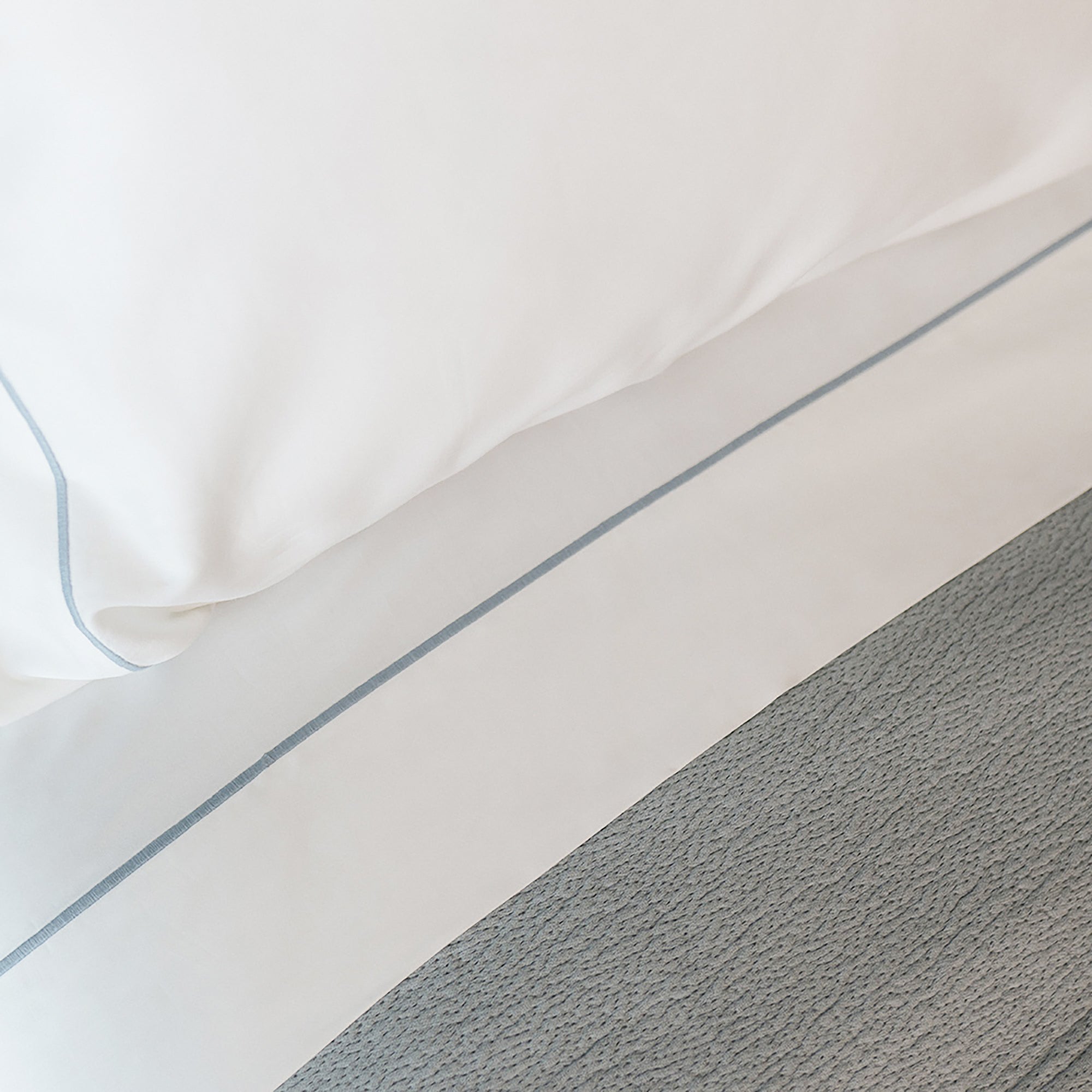 Close-up of organic cotton fabric from the Serene Sheet Set by Rest & Reset, showing a smooth and breathable weave