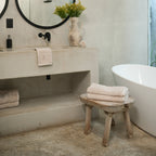 Ritual Bath Towel Set by Rest & Reset styled on a bathroom bench, adding warmth and softness to the space