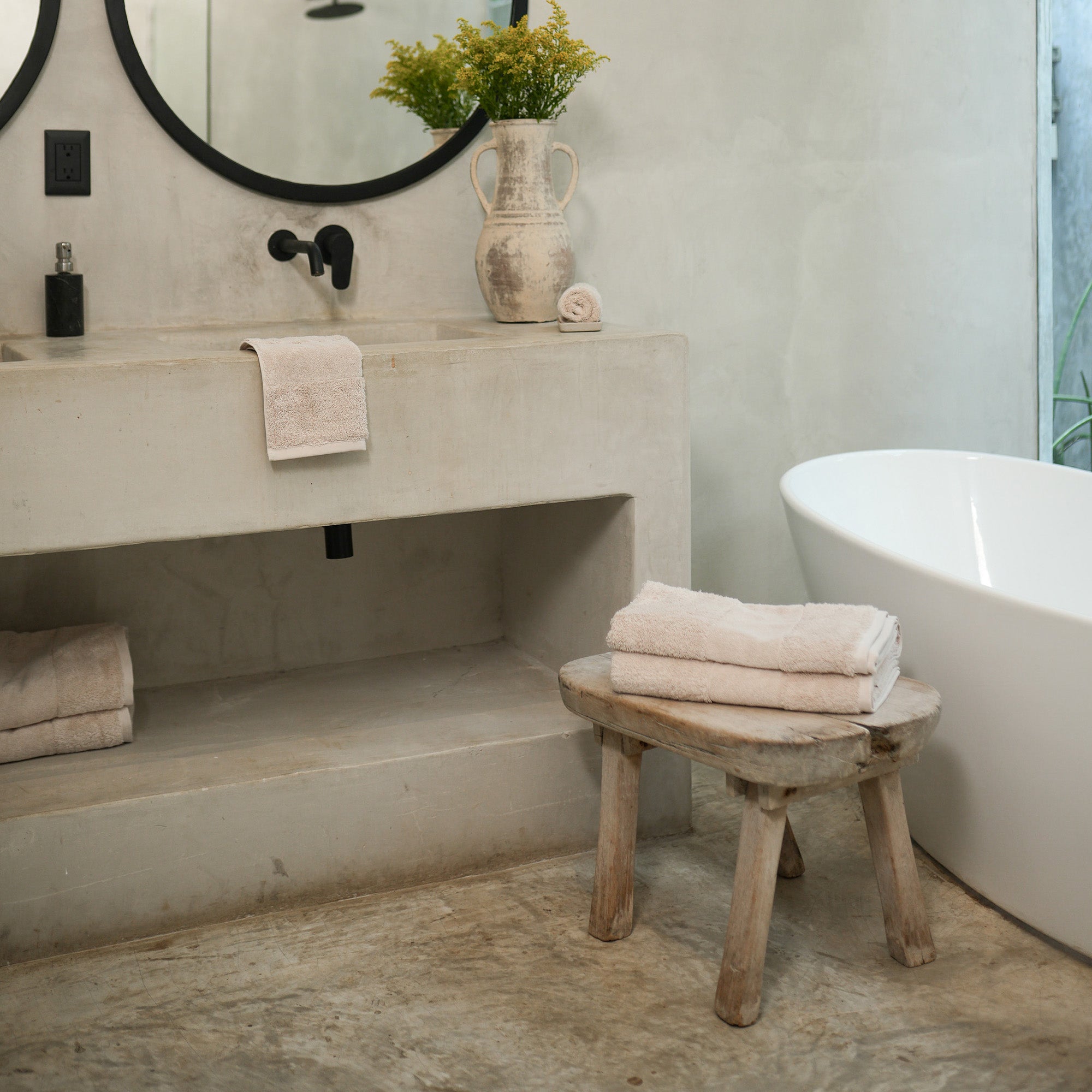 Ritual Bath Towel Set by Rest & Reset styled on a bathroom bench, adding warmth and softness to the space