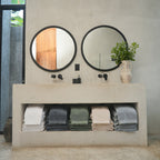 Oasis Bath Towel Set by Rest & Reset styled near the mirror, creating a cohesive and calming bathroom look