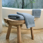 Oasis Bath Towel Set by Rest & Reset styled on a bathroom bench, adding warmth and relaxed luxury to the space