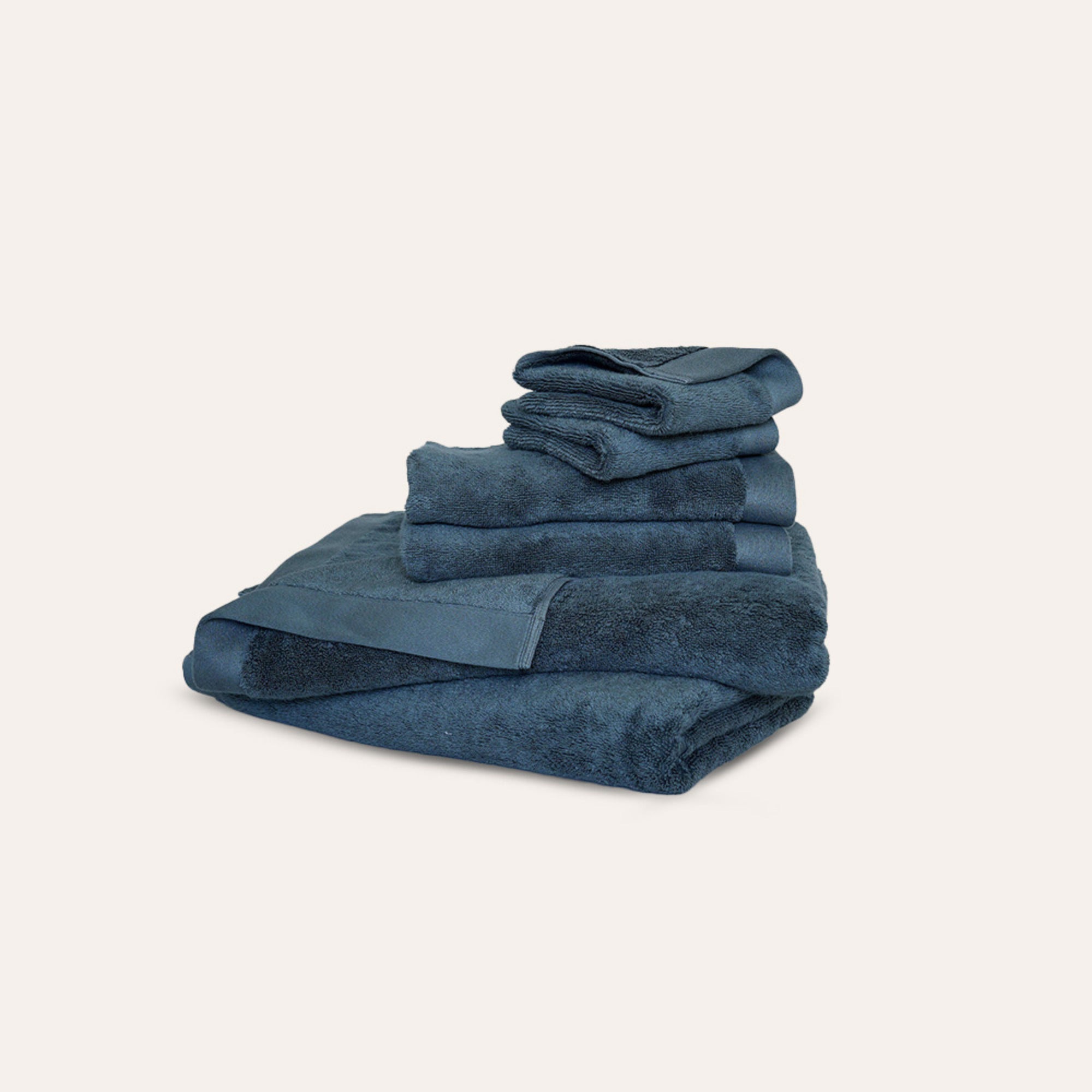 Oasis Bath Towel Set by Rest & Reset folded in a darker shade, highlighting plush organic cotton fabric