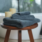 Oasis Bath Towel Set by Rest & Reset styled on a bathroom bench, reinforcing a relaxed and inviting space