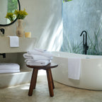 Oasis Bath Towel Set by Rest & Reset styled on a bathroom bench, reinforcing a relaxed and inviting space