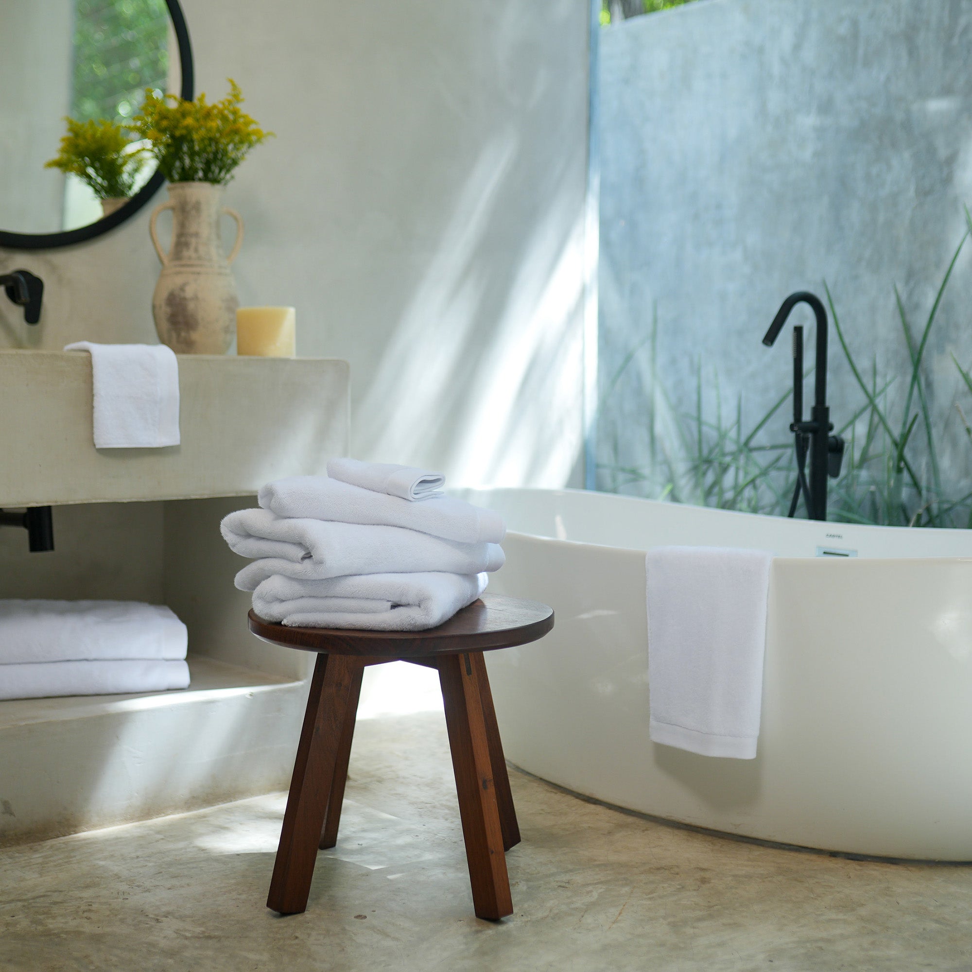 Oasis Bath Towel Set by Rest & Reset styled on a bathroom bench, reinforcing a relaxed and inviting space
