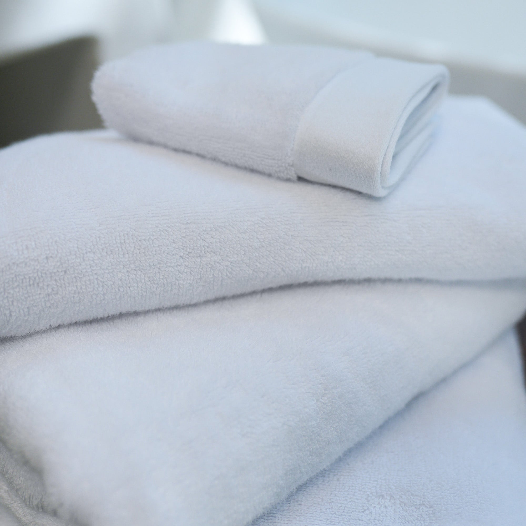 Oasis Bath Towel Set by Rest & Reset folded in a lighter shade, showcasing softness and refined finishing