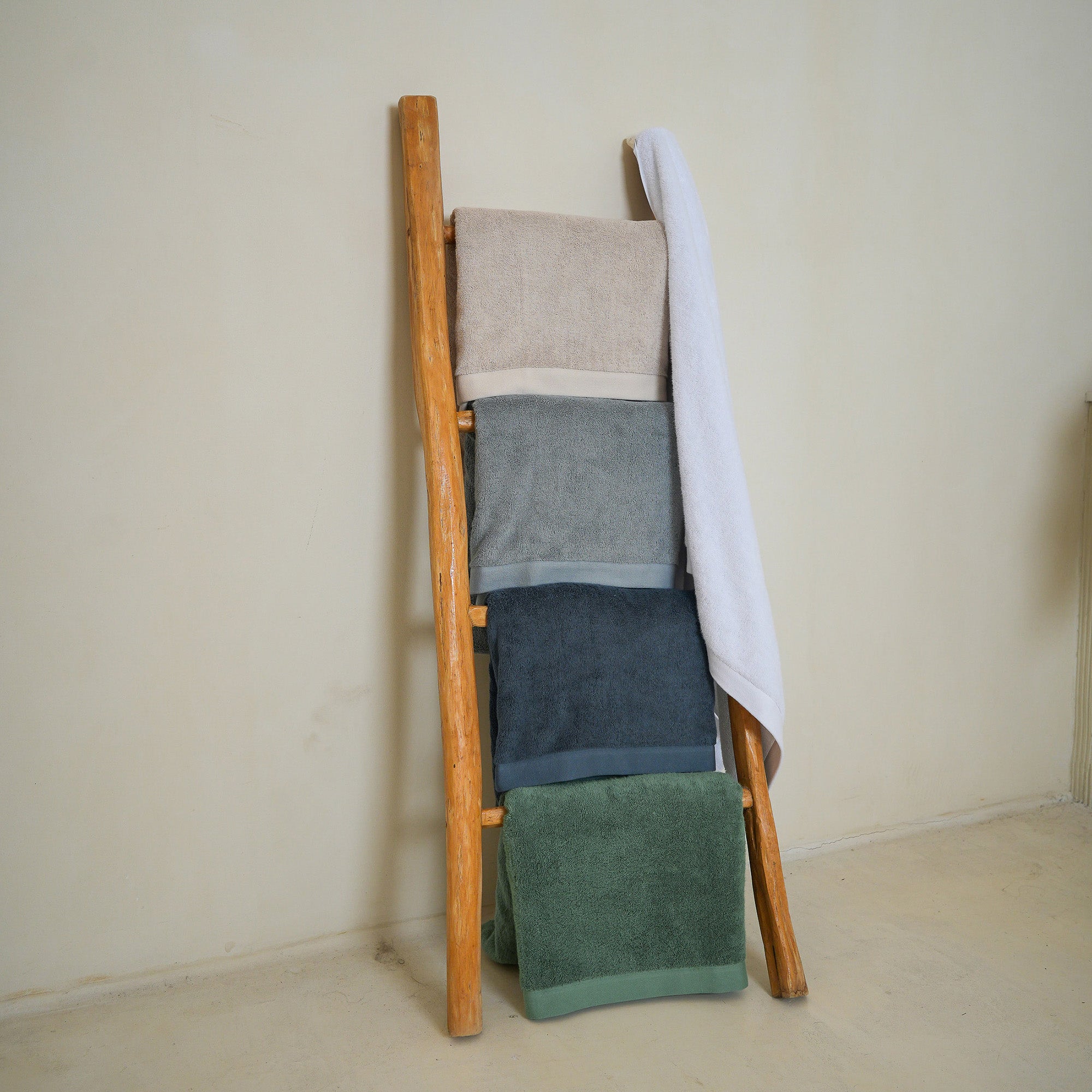 Oasis Bath Towels Pair by Rest & Reset styled on bathroom furniture, combining function and relaxed elegance