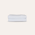 Oasis Bath Towels Pair by Rest & Reset stacked neatly, presenting absorbent towels designed for daily routines