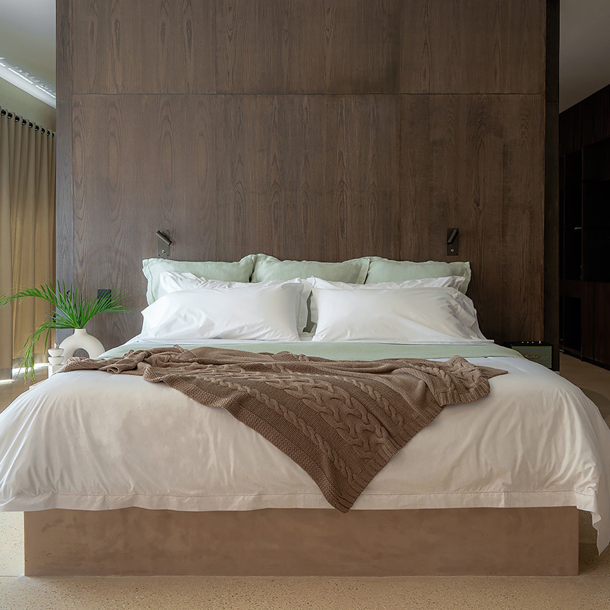 Drift Throw Blanket by Rest & Reset styled on a bed, blending indoor comfort with a relaxed, natural aesthetic
