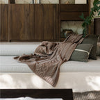 Drift Throw Blanket by Rest & Reset styled on a bed, blending indoor comfort with a relaxed, natural aesthetic