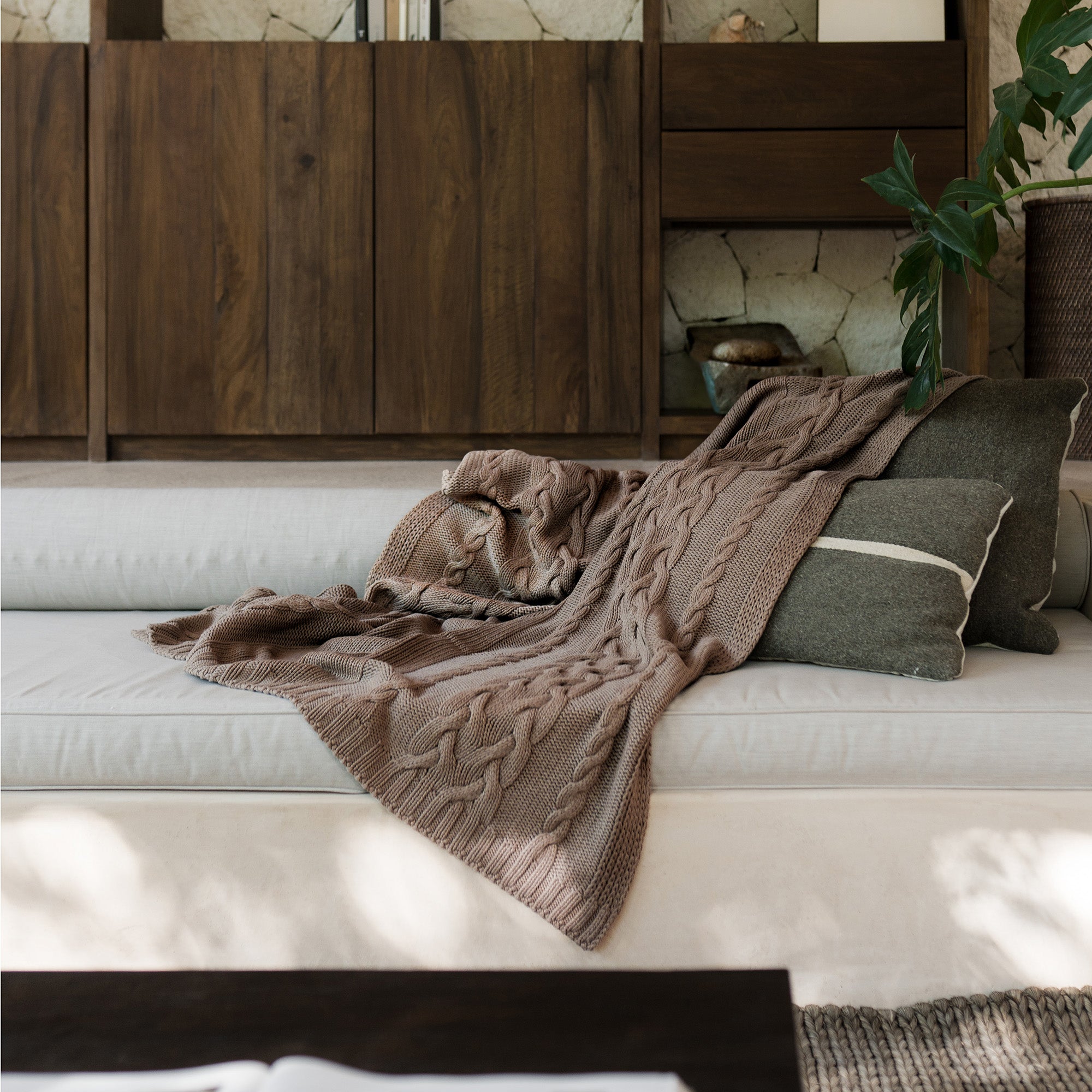 Drift Throw Blanket by Rest & Reset styled on a bed, blending indoor comfort with a relaxed, natural aesthetic