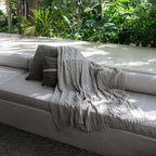 Drift Throw Blanket by Rest & Reset styled outdoors, creating a calm and cozy atmosphere inspired by nature