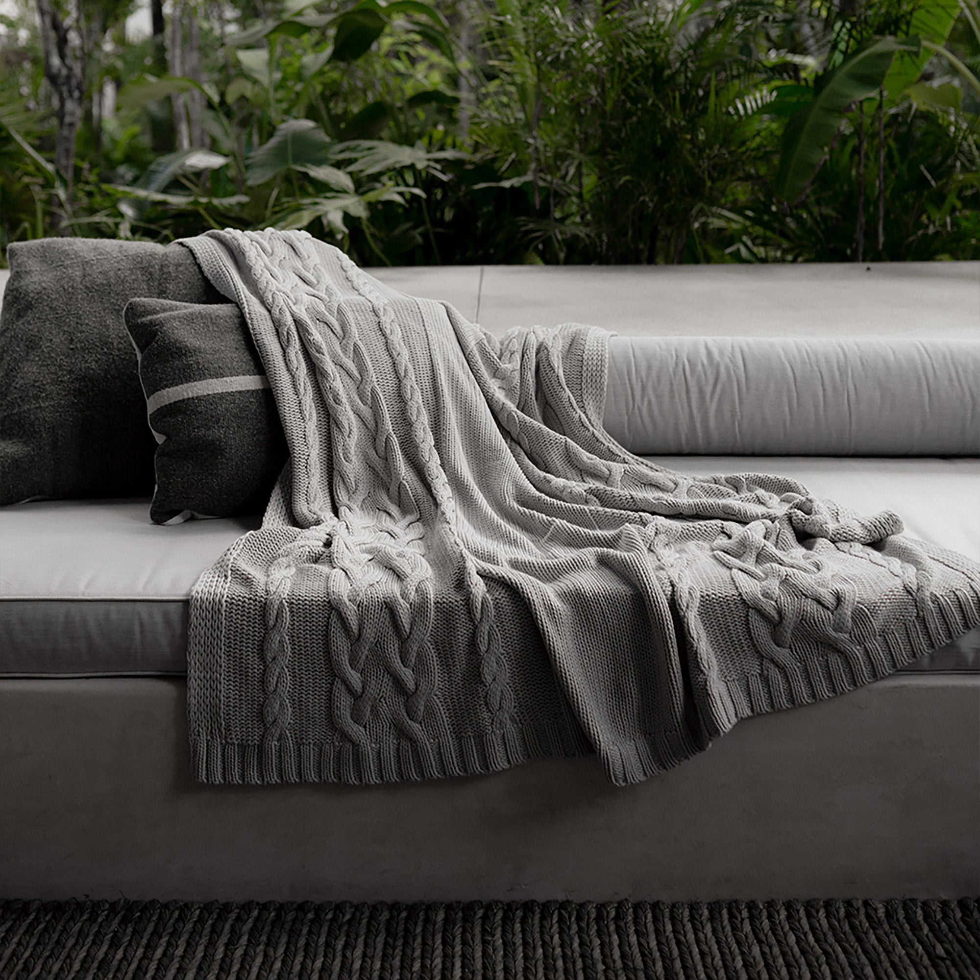 Drift Throw Blanket by Rest & Reset draped in an outdoor setting, designed for relaxed and mindful moments